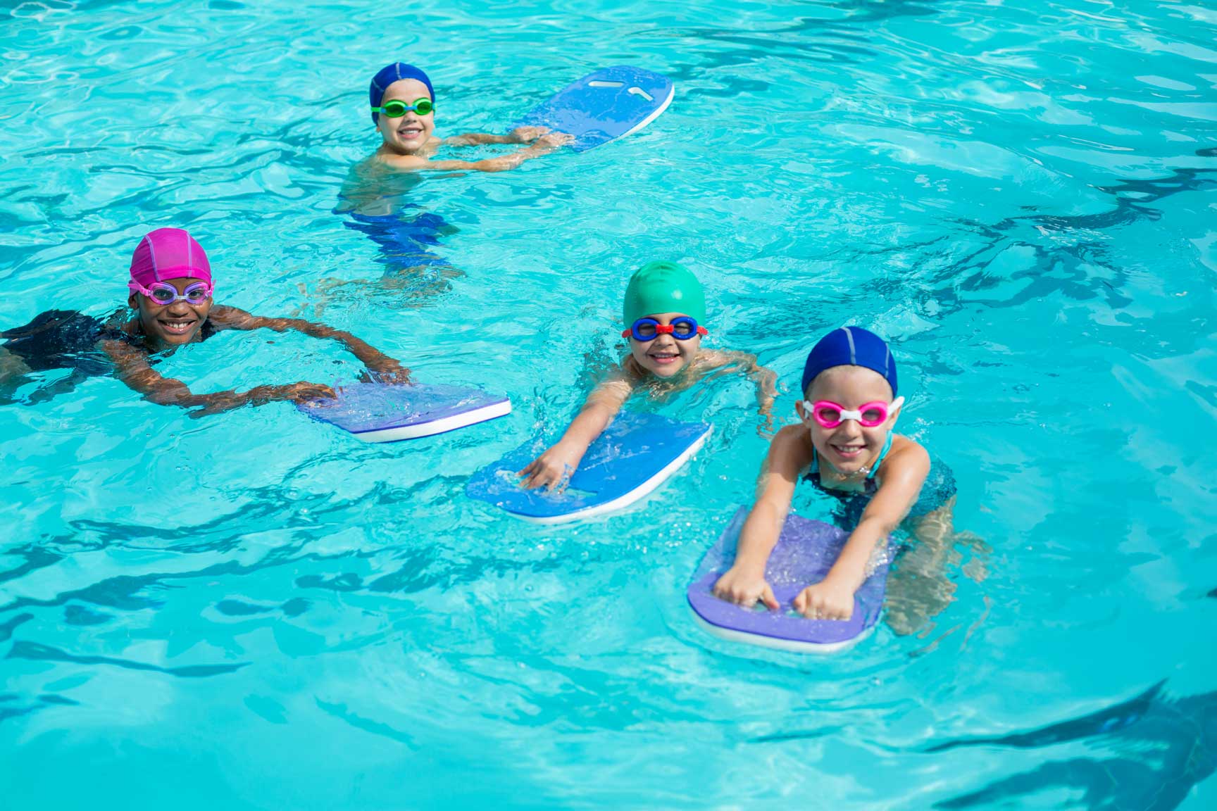 Certified instructor teaching kids essential water safety techniques in a swimming class.