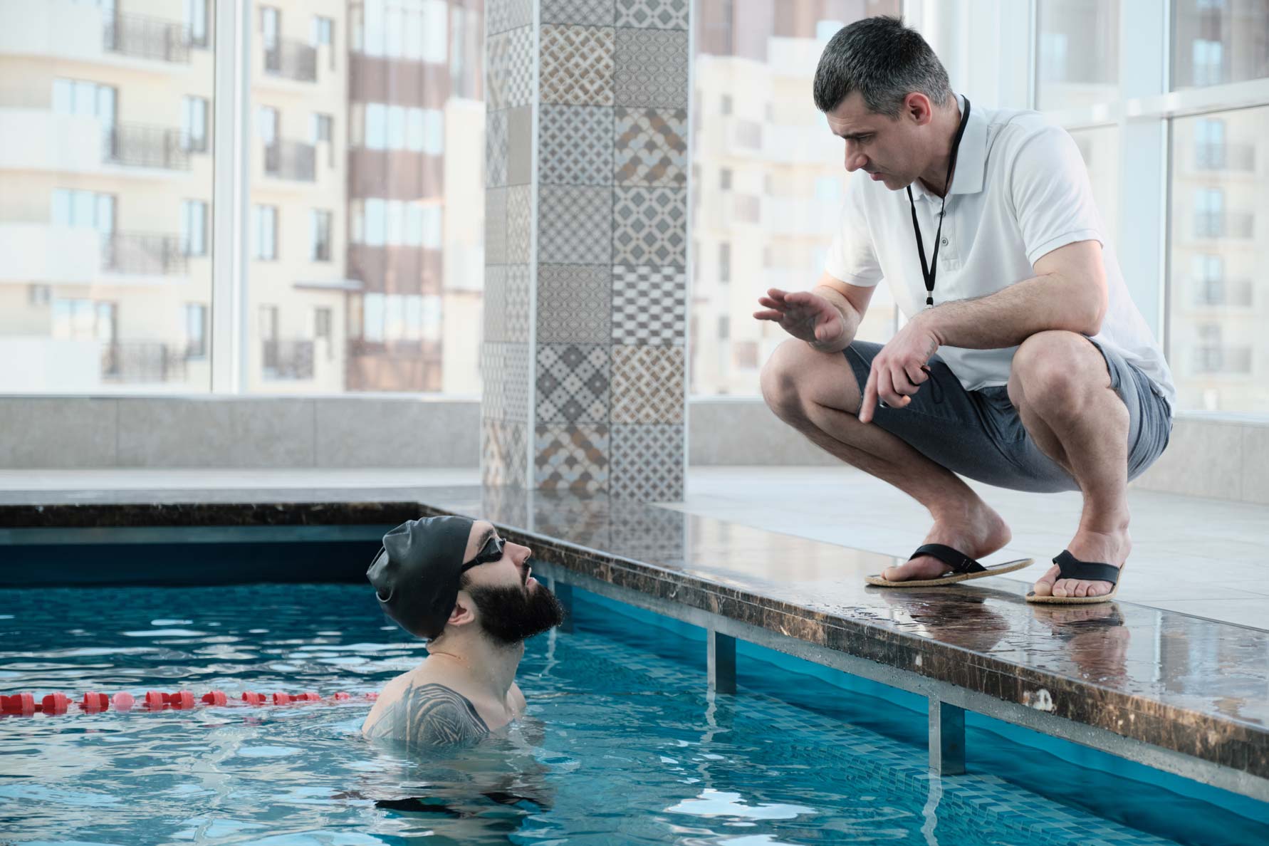 Swimmer receiving personalized coaching from a certified swim instructor in a private lesson.