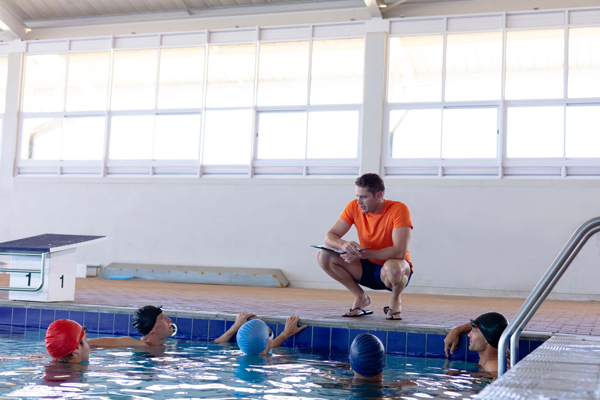 Family learning water safety techniques with a certified swim instructor.